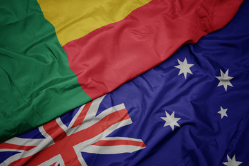 waving colorful flag of australia and national flag of benin.
