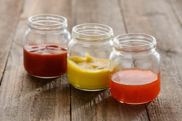 Fototapeta na wymiar Small jars of sauces