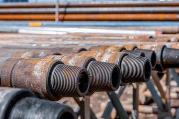 Oil Drill pipe. Rusty drill pipes were drilled in the well section. Downhole drilling rig. Laying...