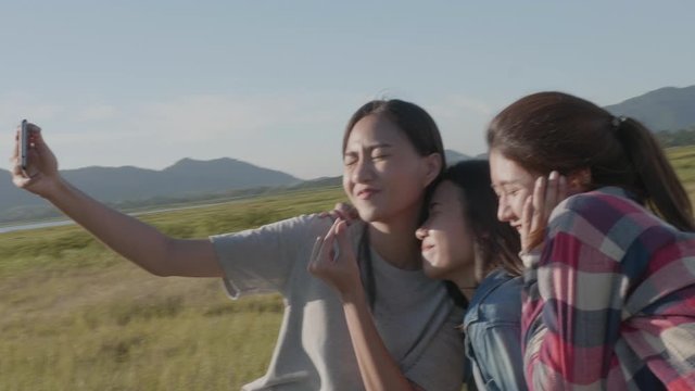 Group of young Asian women doing salfi on the phone, smiling, having fun and happy on summer holiday vacation.
