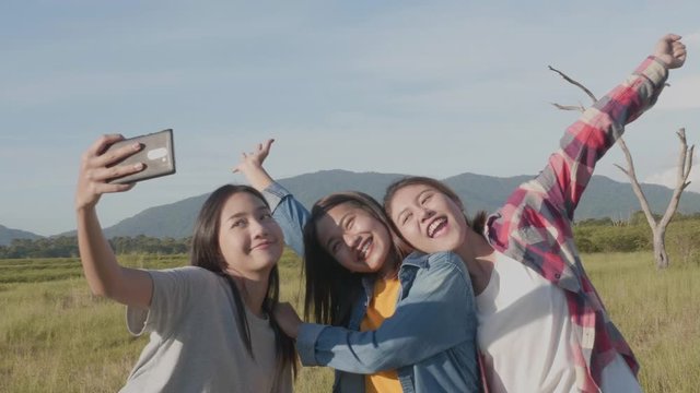 Group of young Asian women doing salfi on the phone, smiling, having fun and happy on summer holiday vacation.