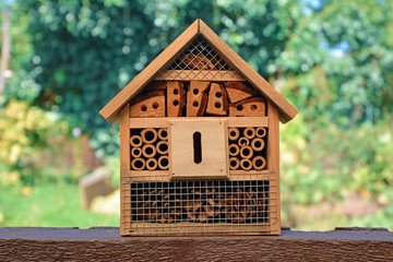 Small wooded insect house hotel used in gardens, a structure created to provide shelter for insects...
