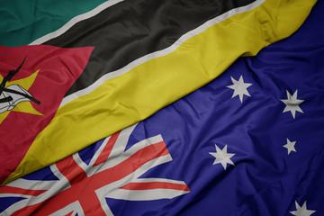 waving colorful flag of australia and national flag of mozambique.