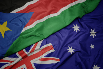 waving colorful flag of australia and national flag of south sudan.