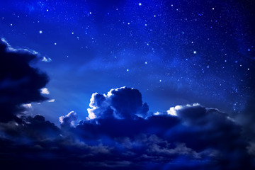 dark cloudy night sky with stars and nebula