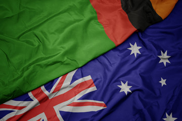waving colorful flag of australia and national flag of zambia.