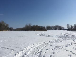 winter rural landscape with frozen river and trees