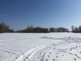 Fototapeta premium winter rural landscape with frozen river and trees