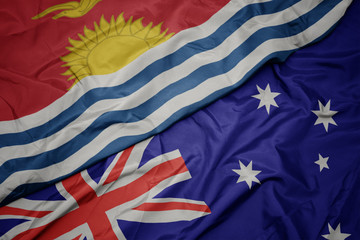 waving colorful flag of australia and national flag of Kiribati.