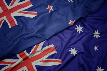 waving colorful flag of australia and national flag of new zealand.