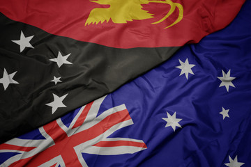 waving colorful flag of australia and national flag of Papua New Guinea.