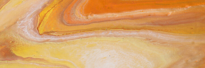photography of abstract marbleized effect background. orange, gold, yellow and white creative colors. Beautiful paint. banner