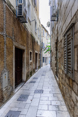 Fototapeta na wymiar Omis old town. Traditional narrow street with stone houses, Dalmatia region, Croatia
