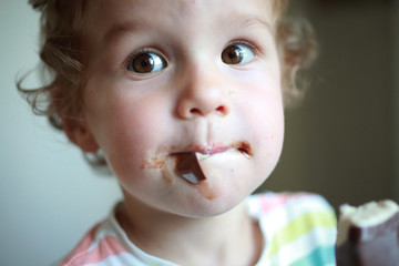 Closeup portrait of little boy eating ice cream