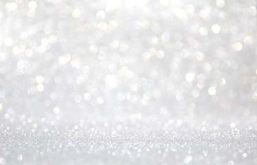 background of abstract glitter lights. silver and white. de-focused