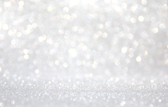 background of abstract glitter lights. silver and white. de-focused