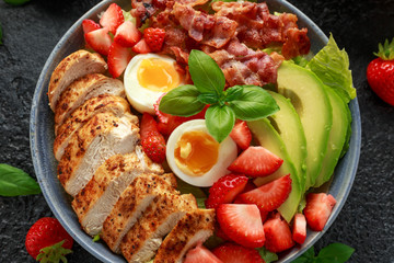 Chicken Cobb salad with strawberries, bacon, avocado and boiled eggs