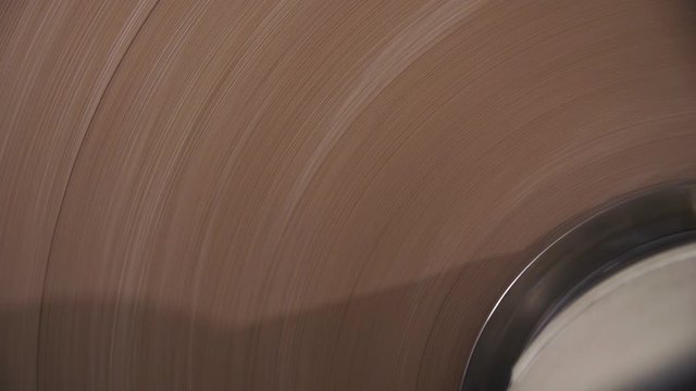 automatic machine reels brown paper in workshop close view