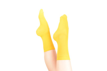 Yellow socks on woman foot isolated on white background.