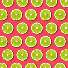 Vibrant fruit pop art background with green lime slices on red background. Minimal flat lay food pattern and texture 