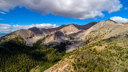 High mountain canyon filled with trees and a tiny bit of snow