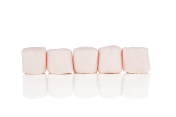 Group of five whole pink sweet fluffy marshmallow in row isolated on white background