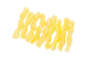 Lot of whole twisted raw pasta gemelli flatlay isolated on white background