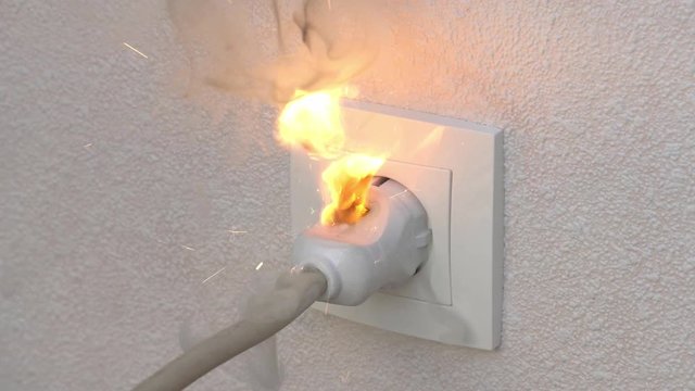 Ignition of outlet during short circuit in apartment. Concept fire from electrical appliances malpractice.