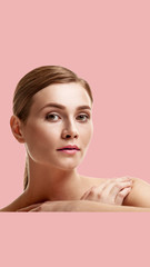 Portrait of beautiful woman with fresh daily makeup isolated on pink background, aspect ratio and...