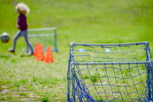 Closeup photo of mini football goal on green lawn