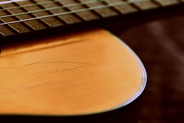 Fragment of an old acoustic guitar close-up