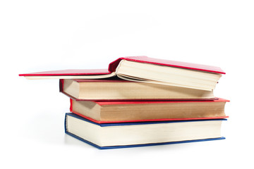 Stack of books, close-up on a white background. The concept of science and education.