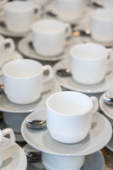 Serving white porcelain coffee and tea cups with saucer