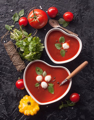 Cold tomato summer vegetable soup Gazpacho in a bowl in the shape of a heart. Vegetarian cuisine.  The view from the top.  The concept of healthy eating.