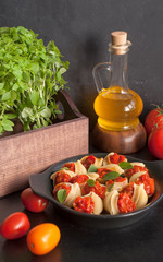 Stuffed large shells pasta with meat and tomatoes in sauce. Italian cuisine.
