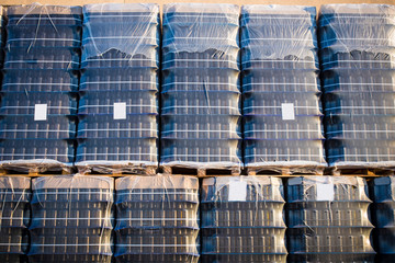 Wrapped empty red wine bottles on pallets