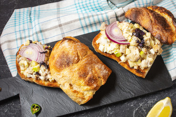 Fish pate, minced herring fillet with apple and egg on toasted rye bread, traditional Jewish cuisine dish forshmak