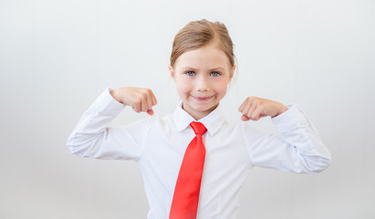 Portrait of a strong girl showing the muscles of his arms on white background