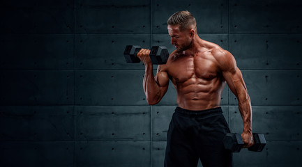 Muscular Men Exercise With Dumbbells , Performing Dumbbell Bicep Curls