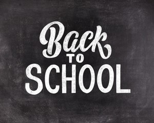 Back to school chalk hand lettering on black chalkboard background. Vintage illustration.