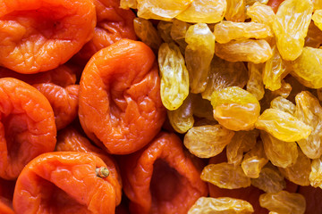 Heap of organic sun dried fruits dehydrated apricots yellow golden raisins. Healthy diet wholefoods vegan concept. Creative food poster wallpaper