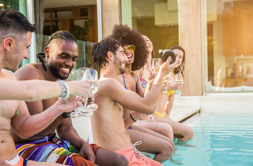 Young people laughing and having fun at vacation in a luxury tropical resort