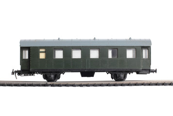 Model of a steam locomotive and cistern on rails on a white background