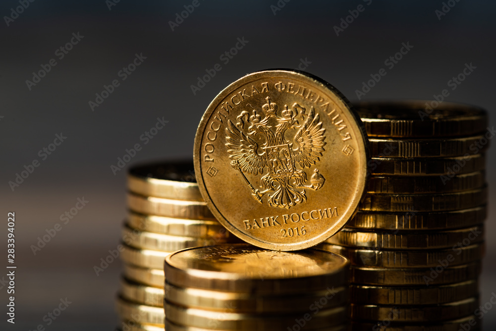 Wall mural The Russian rouble coin and gold coins.