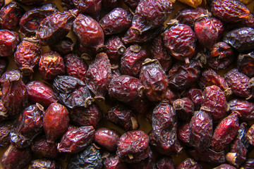 Heap of organic sun dried fruits berries dehydrated rose hip. Healthy diet wholefoods vegan winter beverages ingredients concept. Creative food poster