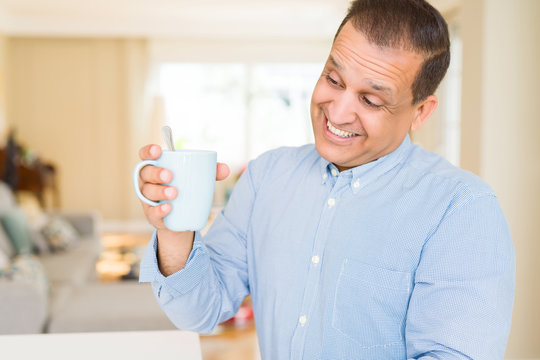 Middle age man enjoying and drinking a cup of coffee at home