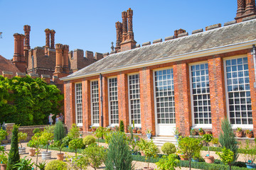 London, UK. English garden view and the East Front of Hampton court 17th century locates West London