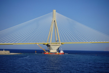 Repair vessel in modern anti seismic cable bridge of Rio Antirio Harilaos Trikoupis that connects Peloponnese to mainland Greece