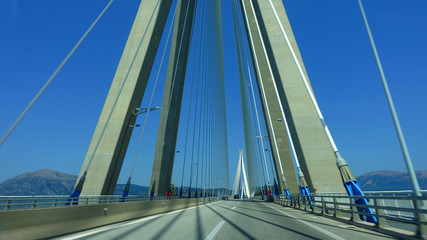 Naklejka premium Driving through famous modern anti seismic cable bridge of Rio Antirio Harilaos Trikoupis that connects Peloponnese to mainland Greece