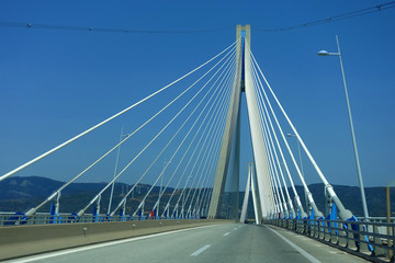 Fototapeta na wymiar Driving through famous modern anti seismic cable bridge of Rio Antirio Harilaos Trikoupis that connects Peloponnese to mainland Greece